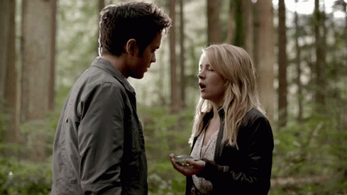 Man And Woman Talking In Woods GIF