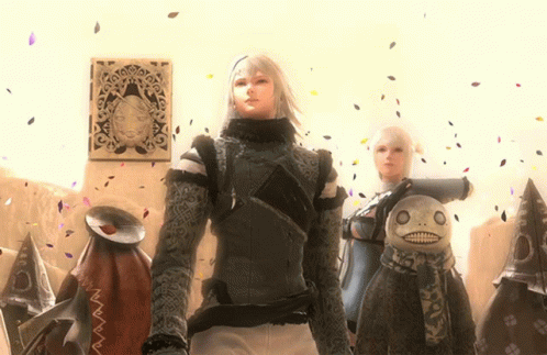 A Man And A Woman Are Standing Next To A Stuffed Animal GIF