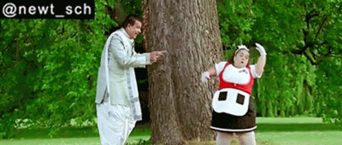 A Man And A Woman Are Standing Next To A Tree With The Hashtag @Newt_sch Below Them GIF