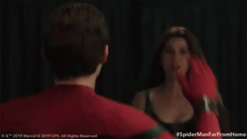 a man and a woman are standing next to each other and giving each other high fives .
