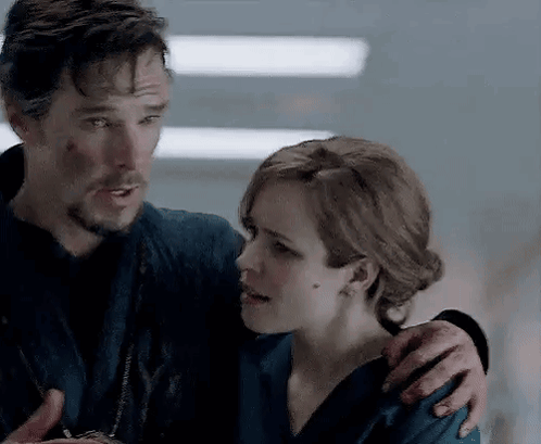 a man and a woman are standing next to each other and hugging .
