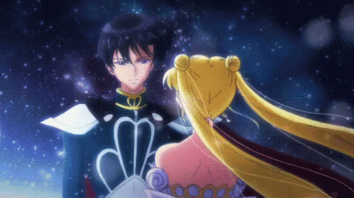 A Man And A Woman Are Standing Next To Each Other And Looking At Each Other GIF