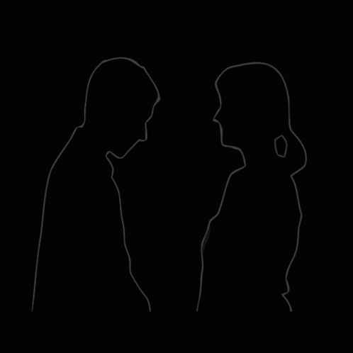 A Man And A Woman Are Standing Next To Each Other And Looking At Each Other . GIF