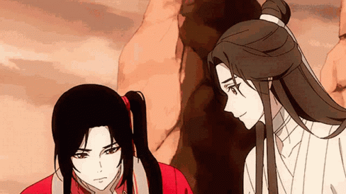 A Man And A Woman Are Standing Next To Each Other And Looking At Each Other . GIF
