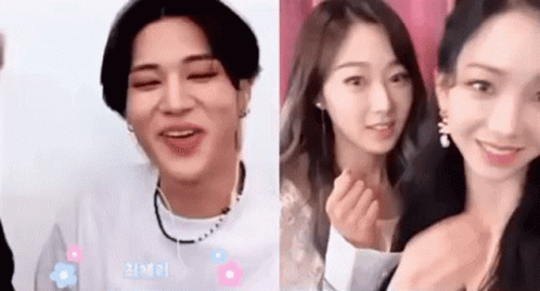 A Man And A Woman Are Standing Next To Each Other And Smiling For The Camera . GIF