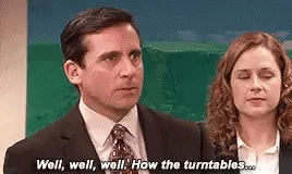 A Man And A Woman Are Standing Next To Each Other And Talking . GIF