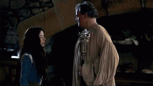A Man And A Woman Are Standing Next To Each Other And Talking . GIF
