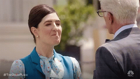 A Man And A Woman Are Standing Next To Each Other And Talking To Each Other . GIF