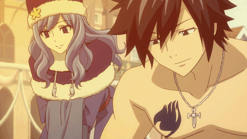 A Man And A Woman Are Standing Next To Each Other And The Man Has A Fairy Tail Tattoo On His Chest GIF