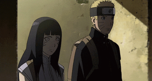 a man and a woman are standing next to each other and the man has a headband with the letter g on it