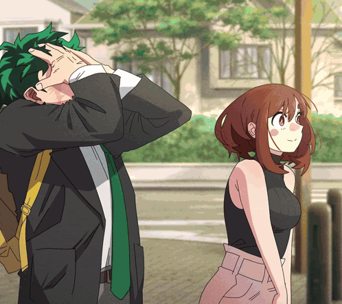 A Man And A Woman Are Standing Next To Each Other And The Man Is Covering His Face GIF