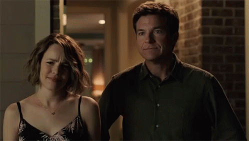 A Man And A Woman Are Standing Next To Each Other And The Man Is Saying " Oh Boy " GIF