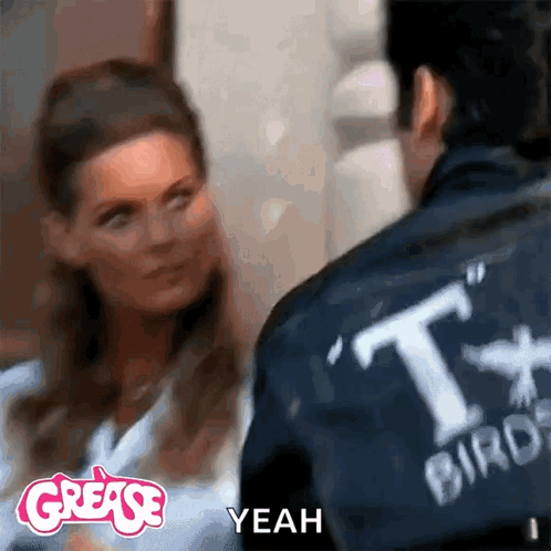 A Man And A Woman Are Standing Next To Each Other And The Man Is Wearing A Jacket That Says " T-Bird " GIF
