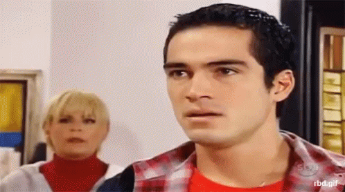 a man and a woman are standing next to each other and the man is wearing a red shirt