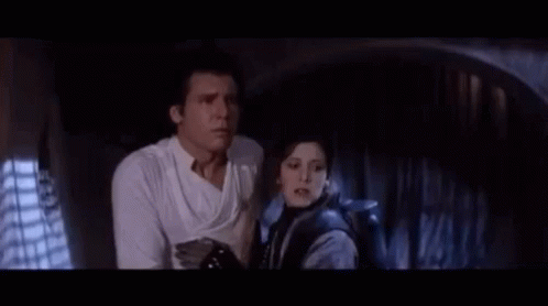A Man And A Woman Are Standing Next To Each Other And The Man Says " I Know That Laugh " GIF