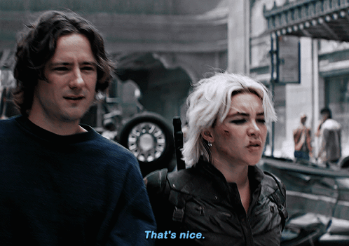 A Man And A Woman Are Standing Next To Each Other And The Man Says That 'S Nice GIF