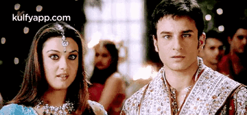 A Man And A Woman Are Standing Next To Each Other And The Website Kulfyapp.com Is Visible In The Corner GIF