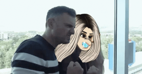A Man And A Woman Are Standing Next To Each Other And The Woman Has A Pacifier In Her Mouth GIF