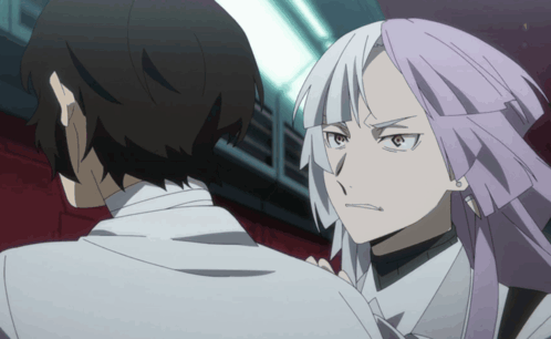 A Man And A Woman Are Standing Next To Each Other And The Woman Has Purple Hair GIF