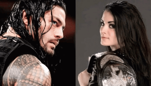 A Man And A Woman Are Standing Next To Each Other And The Woman Is Holding A Championship Belt GIF