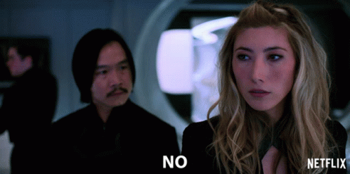 A Man And A Woman Are Standing Next To Each Other And The Woman Is Saying " No " GIF