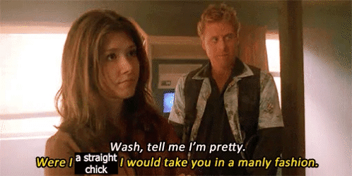 A Man And A Woman Are Standing Next To Each Other And The Woman Is Talking To The Man About Her Appearance . GIF