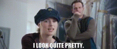 A Man And A Woman Are Standing Next To Each Other And The Woman Is Wearing A Police Hat . GIF