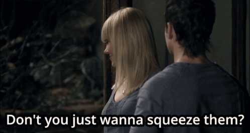 A Man And A Woman Are Standing Next To Each Other And The Woman Says " Don T You Just Wanna Squeeze Them " GIF
