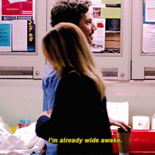 A Man And A Woman Are Standing Next To Each Other And The Woman Says I 'M Already Wide Awake GIF