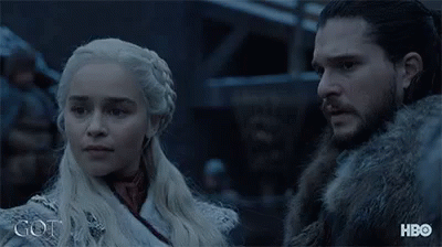A Man And A Woman Are Standing Next To Each Other And The Word Got Is On The Bottom Right GIF