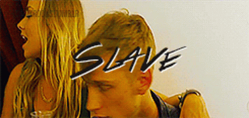 A Man And A Woman Are Standing Next To Each Other And The Word Slave Is On The Bottom GIF