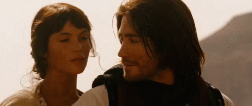 A Man And A Woman Are Standing Next To Each Other GIF