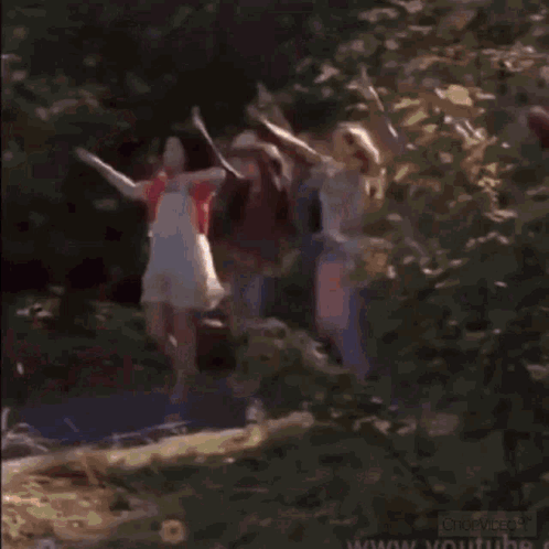 A Man And A Woman Are Standing Next To Each Other In A Blurry Photo . GIF