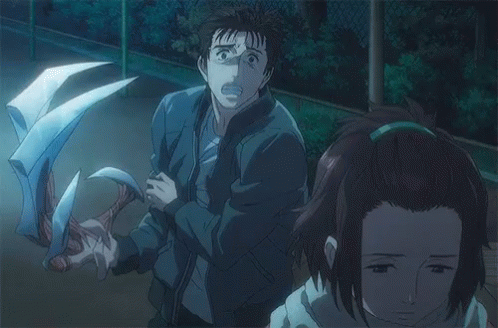 A Man And A Woman Are Standing Next To Each Other In A Dark Room With A Monster Behind Them . GIF