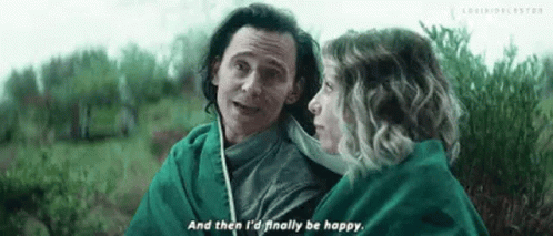 A Man And A Woman Are Standing Next To Each Other In A Field . GIF