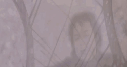 A Man And A Woman Are Standing Next To Each Other In A Foggy Room GIF