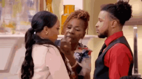 A Man And A Woman Are Standing Next To Each Other In A Living Room . GIF