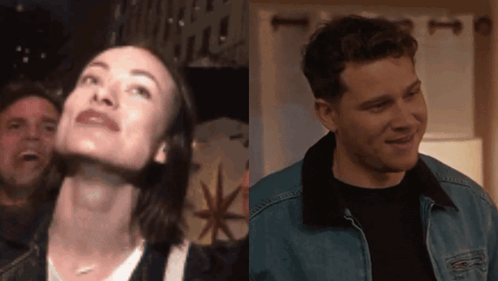 A Man And A Woman Are Standing Next To Each Other In A Room GIF