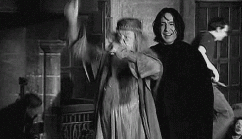 a man and a woman are standing next to each other in a room in a black and white photo .