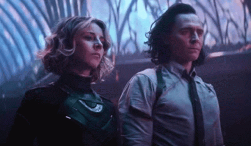 A Man And A Woman Are Standing Next To Each Other In A Room In A Movie . GIF