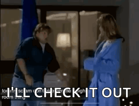 A Man And A Woman Are Standing Next To Each Other In A Room With The Words I 'Ll Check It Out . GIF
