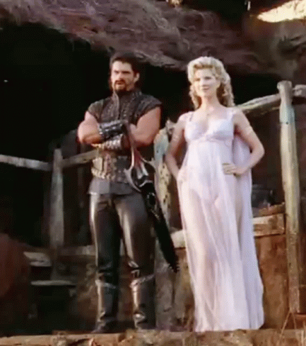 Man And Woman Standing Next To Fence GIF