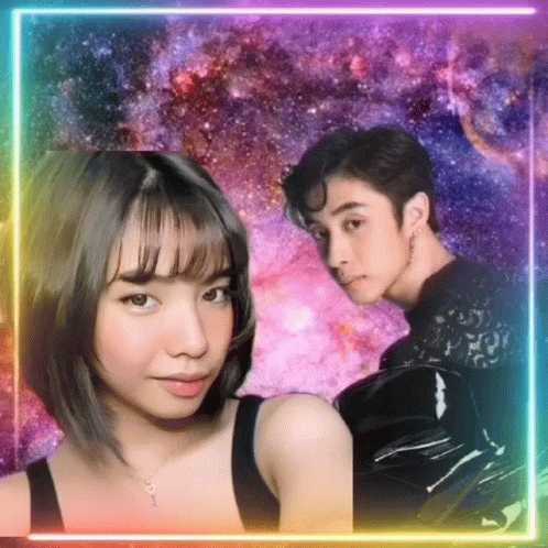 A Man And A Woman Are Standing Next To Each Other In Front Of A Galaxy Background . GIF