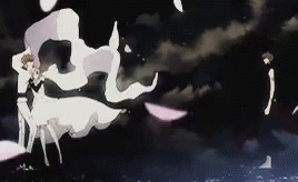A Man And A Woman Are Standing Next To Each Other In The Dark . GIF