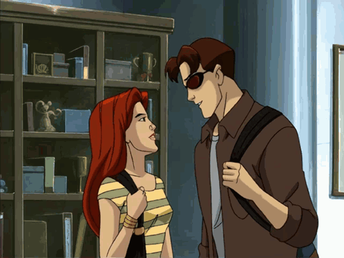A Man And A Woman Are Standing Next To Each Other GIF