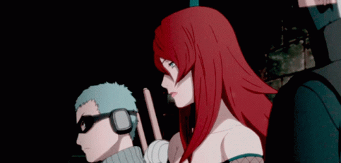 A Man And A Woman Are Standing Next To Each Other GIF