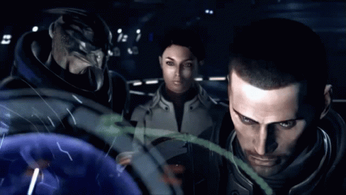 A Man And A Woman Are Standing Next To Each Other Looking At Something GIF