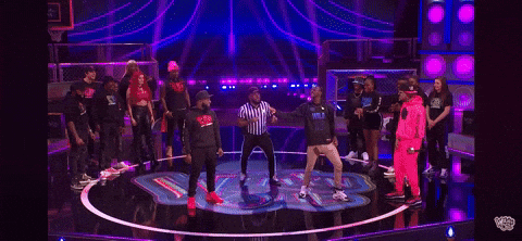 A Man And A Woman Are Standing Next To Each Other On A Stage . The Man Is Wearing A Hoodie That Says Wild GIF