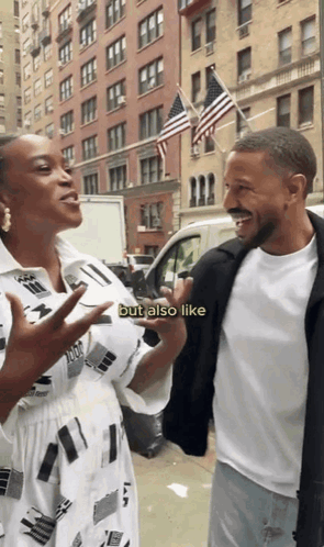 A Man And A Woman Are Standing Next To Each Other On A Street And The Woman Says But Also Like GIF