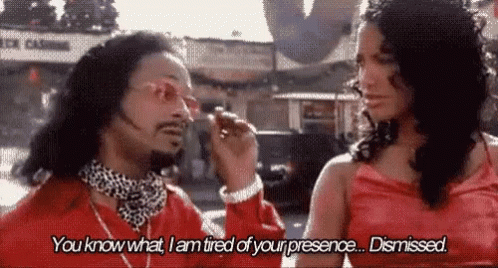 A Man And A Woman Are Standing Next To Each Other On A Street . GIF